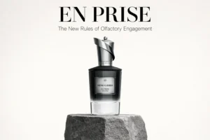 Glass perfume bottle with silver chess-piece cap on a dark reflective surface.