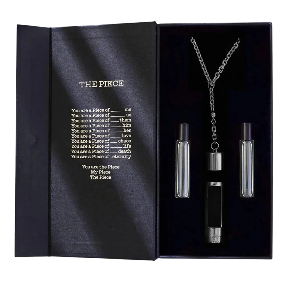 A sleek black unisex fragrance gift set by NCP Olfactives featuring a necklace and ampoules
