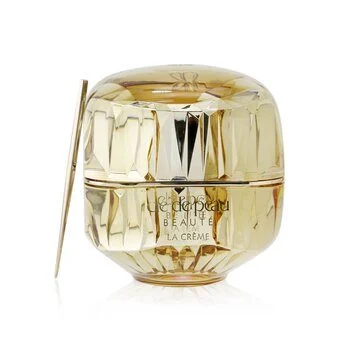 The elegant gold jar of Clé de Peau Beauté La Crème on a minimalist vanity