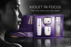 Four white and purple Tatcha skincare products arranged elegantly on a clean surface including a jar and bottles.