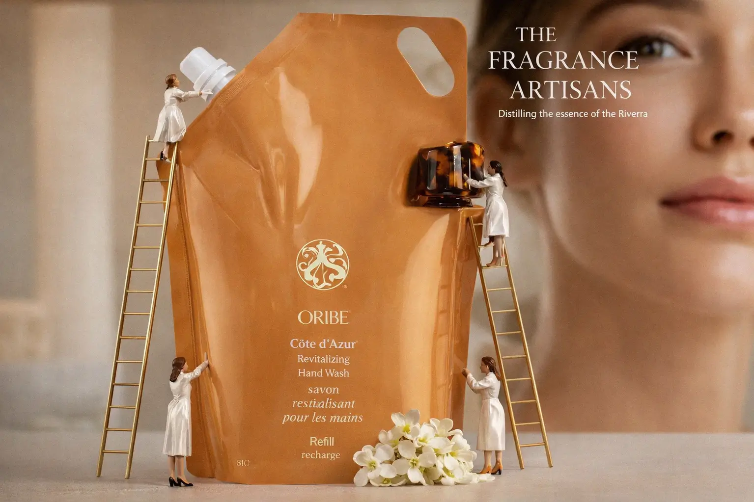 Oribe Cote d'Azur perfume bottle with a custom tortoiseshell cap sitting on a polished white marble vanity.