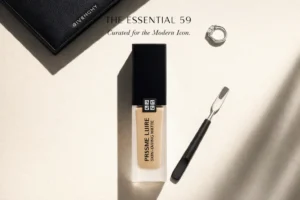 A frosted glass bottle of Givenchy Prisme Libre foundation on a clean, white marble vanity.