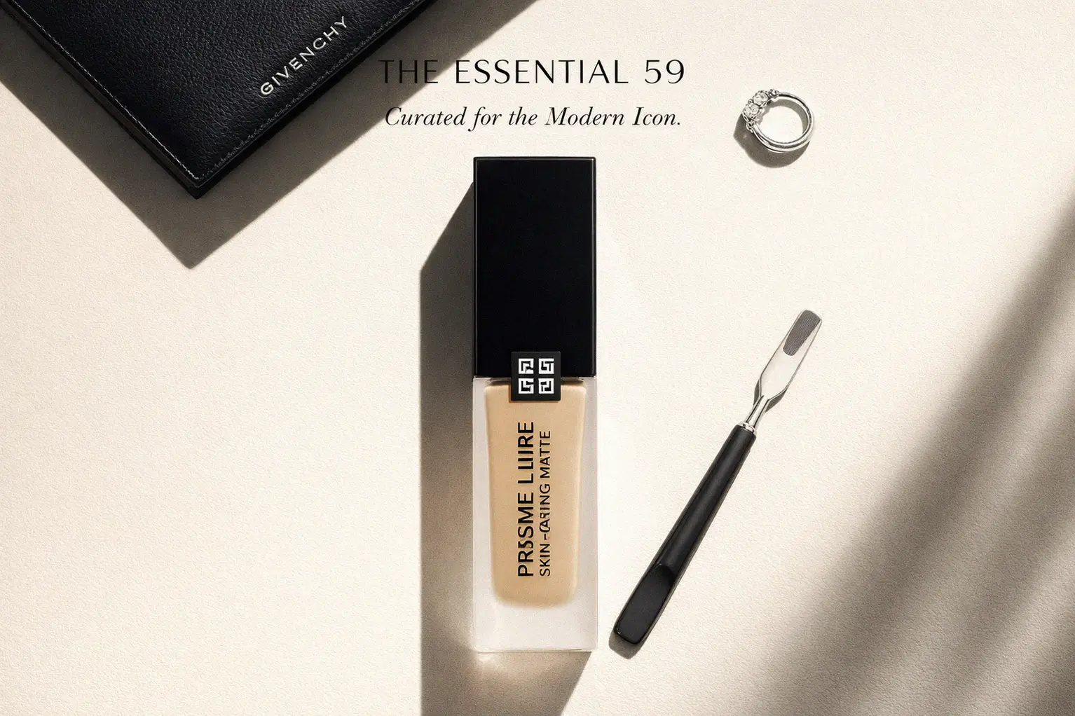 A frosted glass bottle of Givenchy Prisme Libre foundation on a clean, white marble vanity.