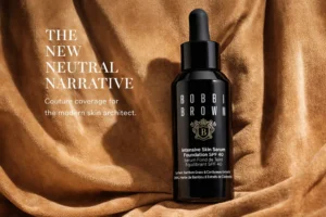 Bobbi Brown Intensive Skin Serum Foundation glass bottle with pump on a polished vanity surface.