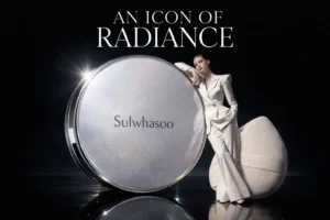 Sulwhasoo Perfecting Cushion in a mother-of-pearl compact with a water-drop shaped puff on a clean surface.