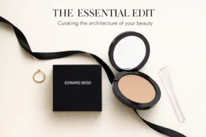 A sleek mirrored compact of Edward Bess Flawless Illusion Foundation open to show the cream texture.