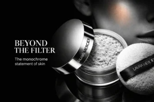 Laura Mercier Ultra-Blur setting powder jar with a soft puff on a polished white vanity.