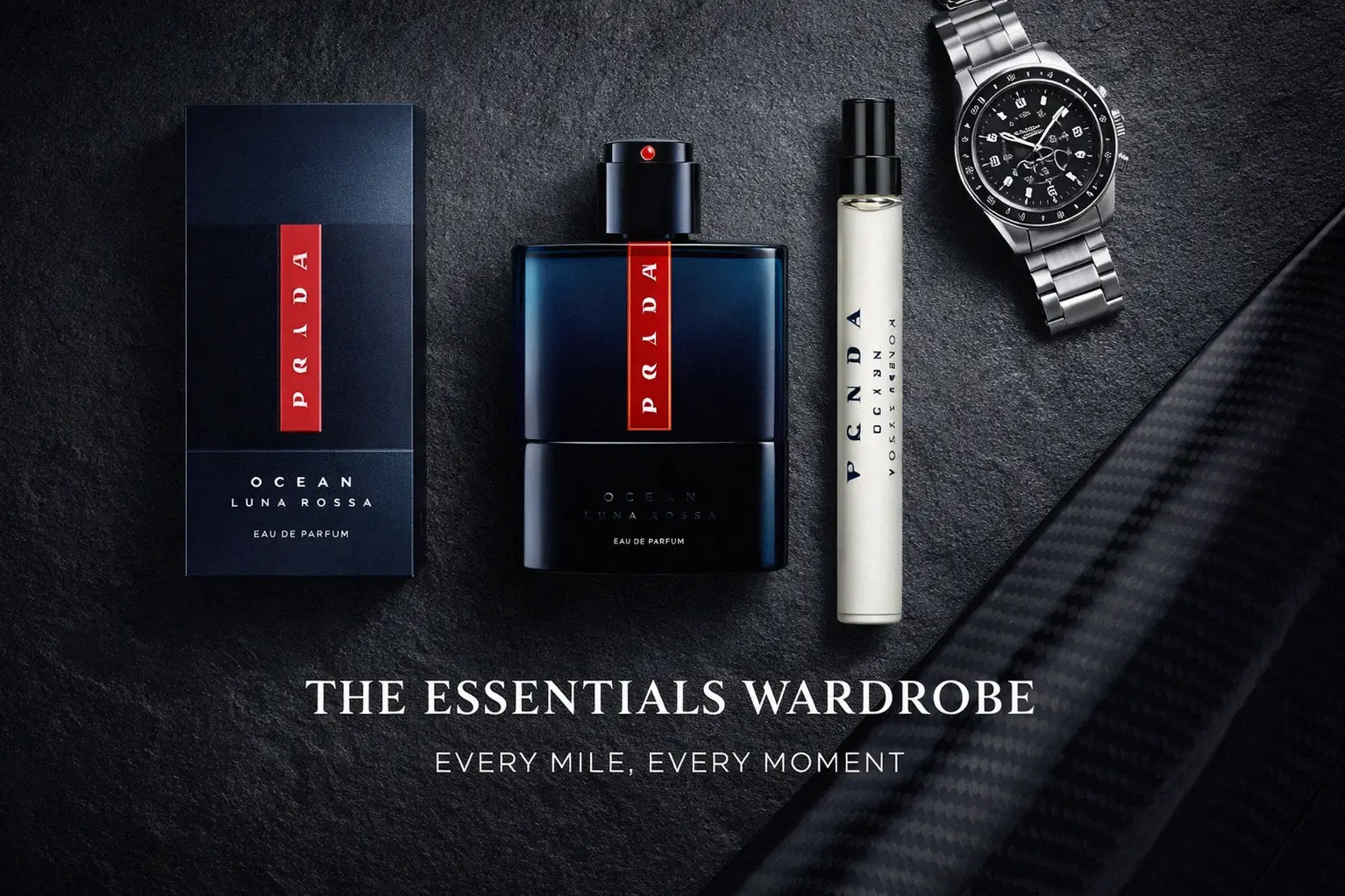 A deep blue Prada Luna Rossa Ocean perfume bottle and travel spray in a designer gift box on a clean surface.
