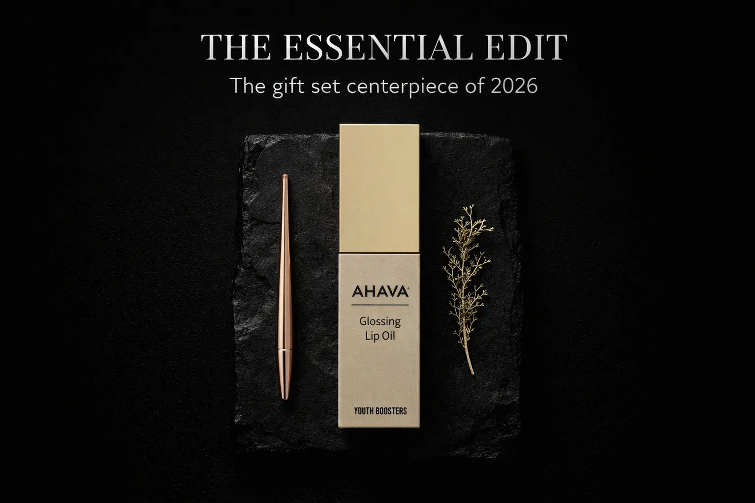 A sleek tube of AHAVA Glossing Lip Oil with a soft curved applicator shown on a clean vanity.