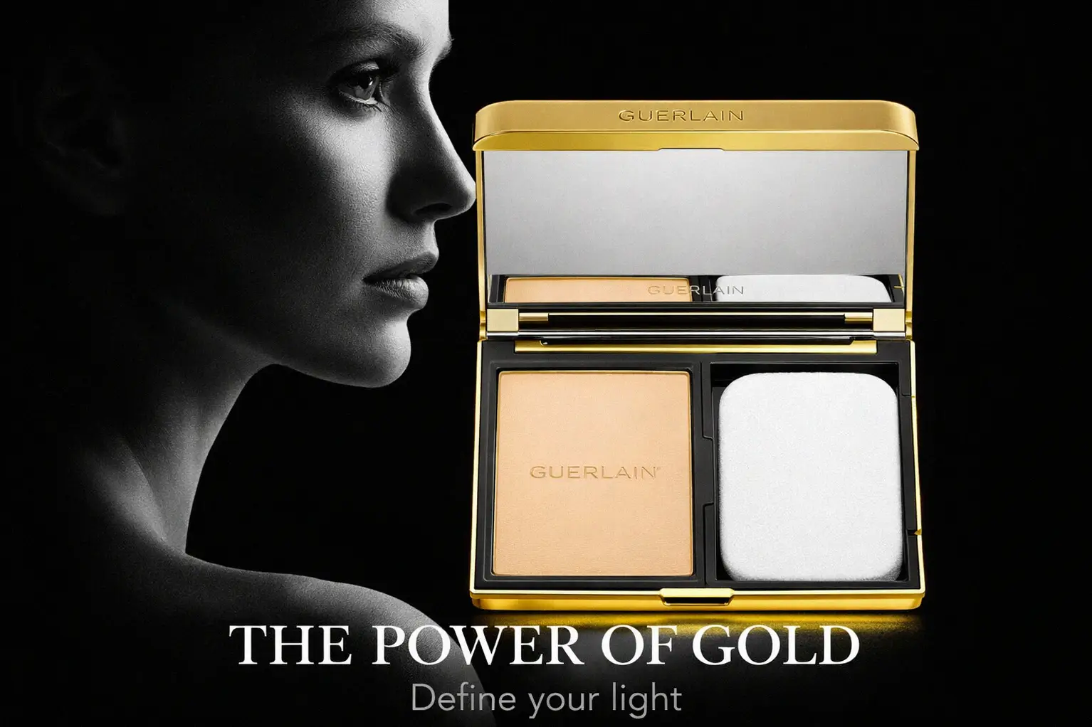 Gold rectangular Guerlain compact foundation open to show matte powder and a mirror on a clean surface.