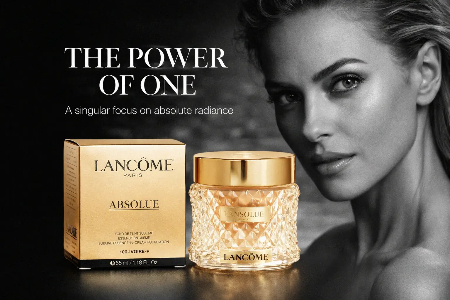 A luxurious glass jar of Lancôme Absolue cream foundation with a gold lid on a marble surface.