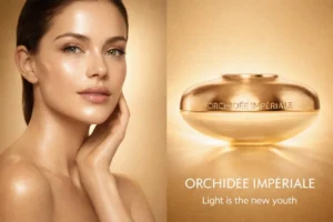 A frosted glass bottle of Guerlain Orchidee Imperiale Gold Nobile Serum with a gold and silver dispenser.