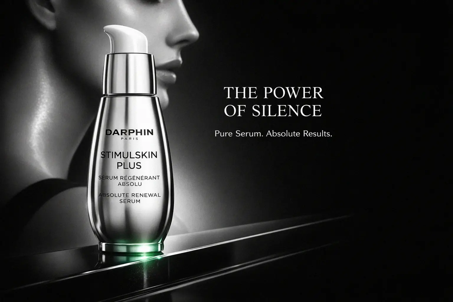 A 1 oz bottle of Darphin Stimulskin Plus Absolute Renewal Serum on a white marble surface with soft lighting.