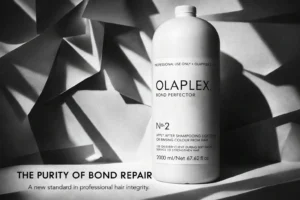 Large white bottle of Olaplex No. 2 Bond Perfector on a clean marble vanity with a minimalist aesthetic.