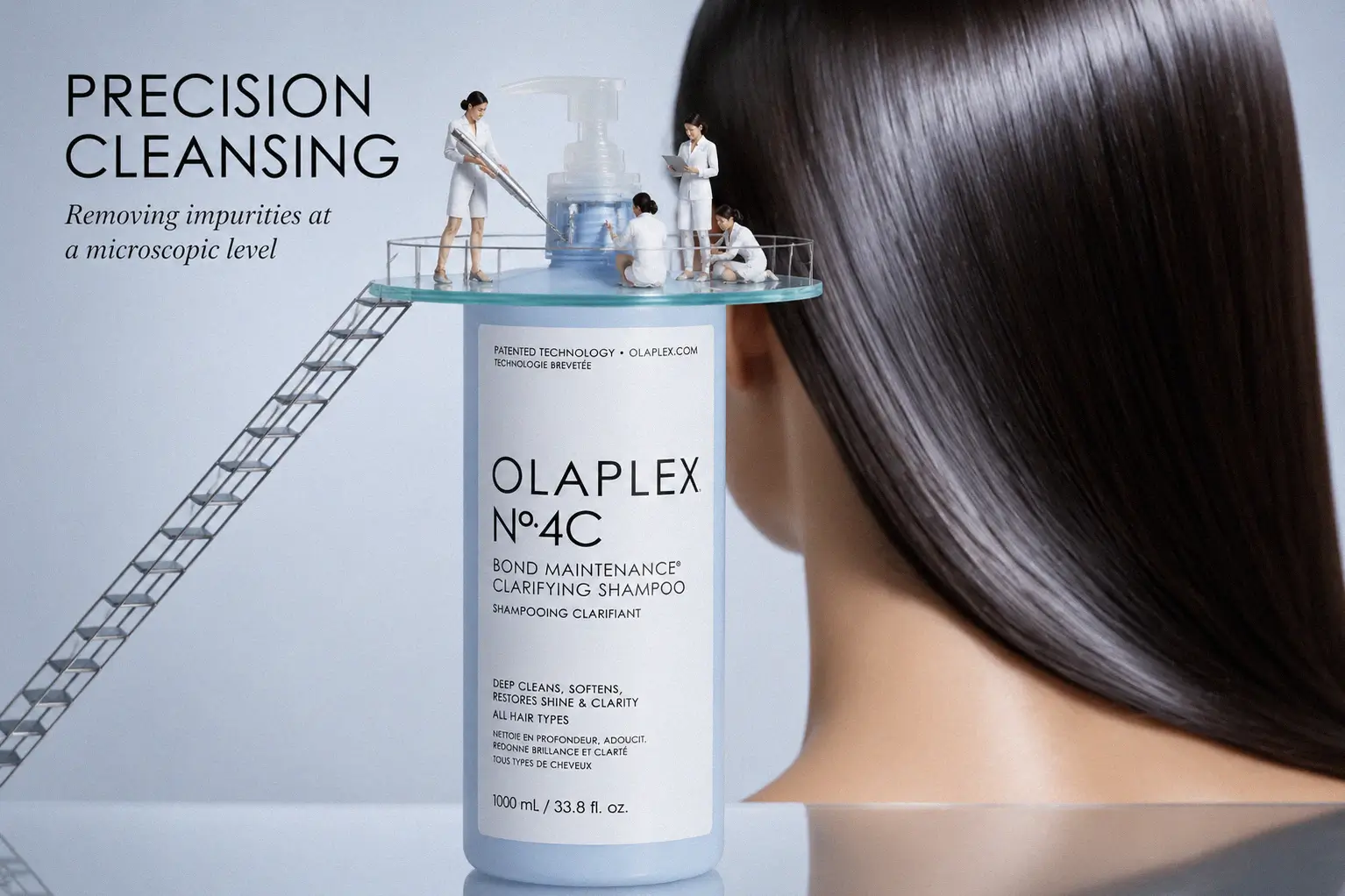 Large Olaplex No. 4C white bottle with minimalist black labeling on a marble bathroom shelf.