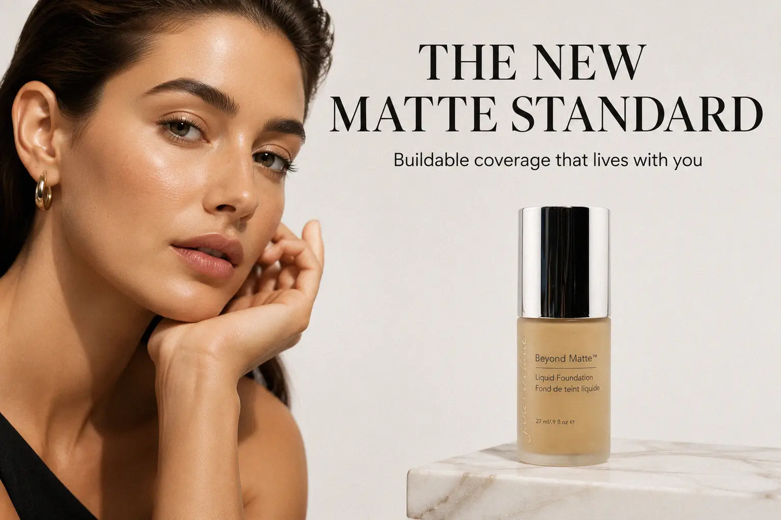 A glass pump bottle of jane iredale Beyond Matte Liquid Foundation on a clean marble surface.