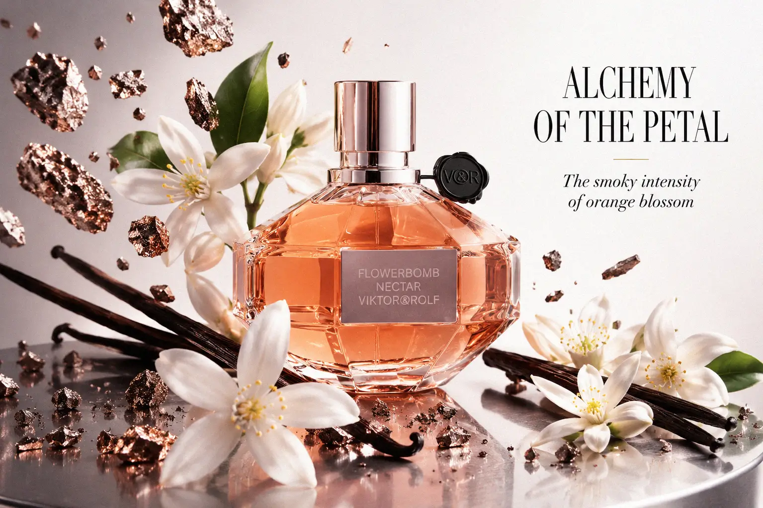 A faceted glass bottle of Flowerbomb Nectar with a rose gold liquid and black seal.