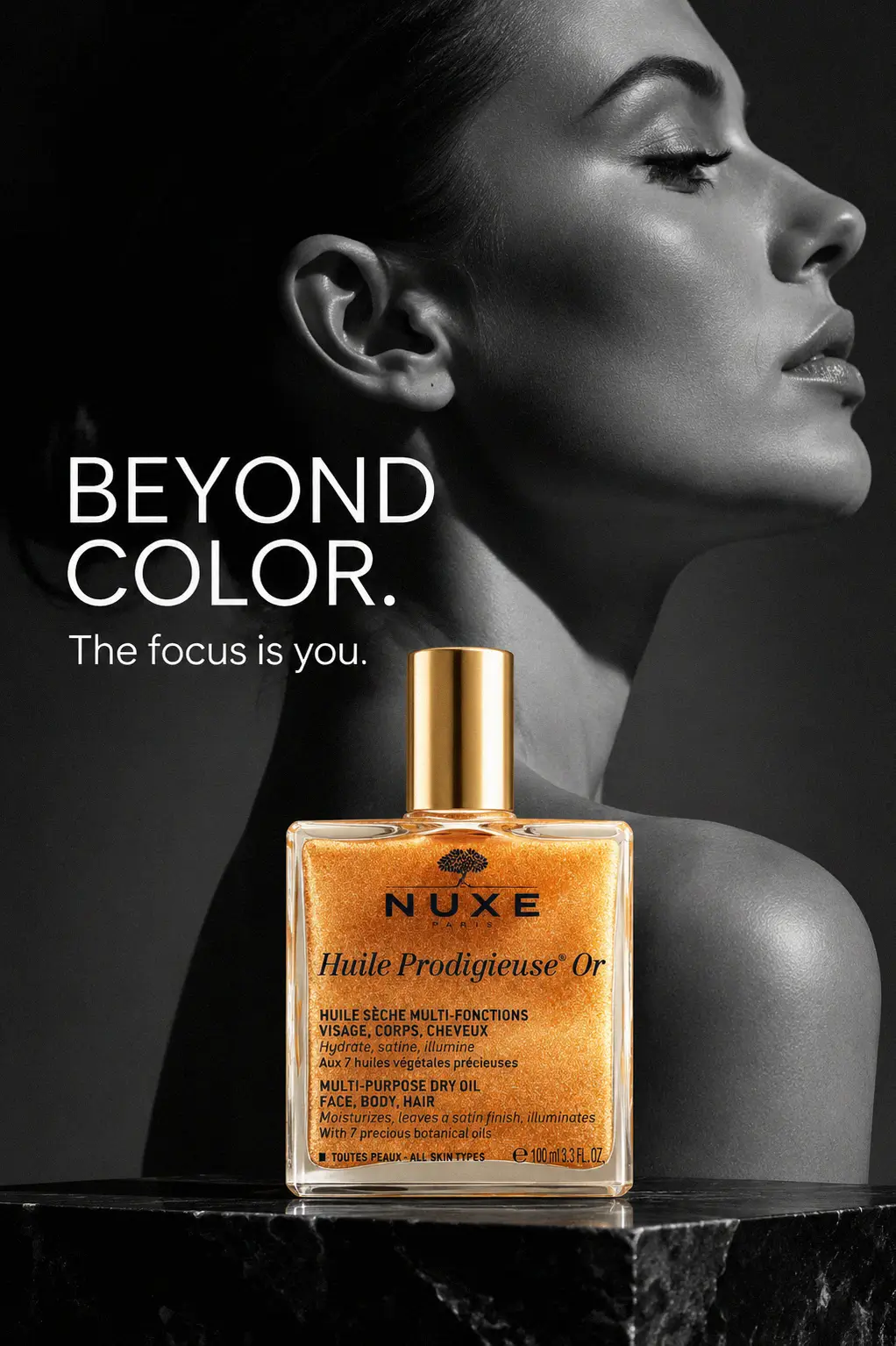 Model applying shimmering oil to skin for a golden hour glow