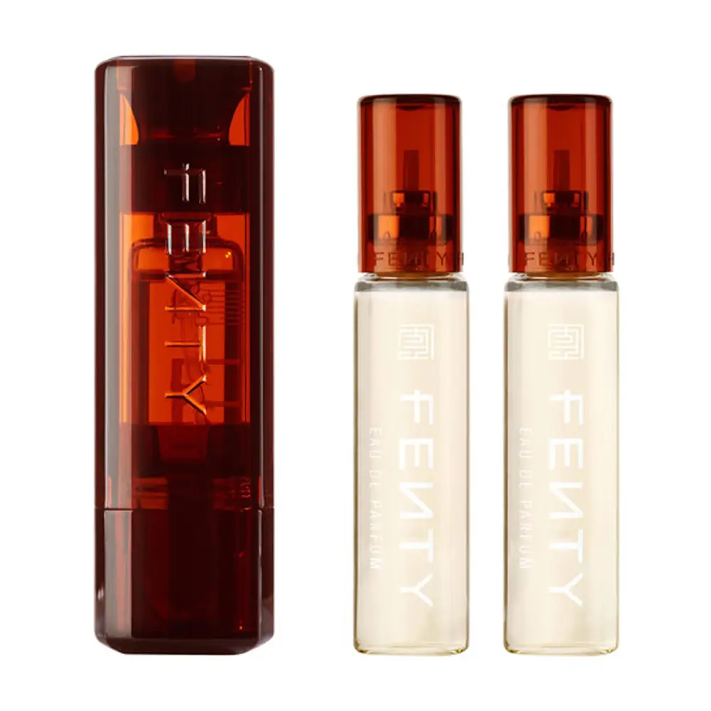 The Fenty Eau De Parfum Refillable Travel Set displayed in its sleek copper-toned case