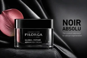 A premium glass jar of Filorga Global-Repair Advanced Cream sitting on a polished marble surface.