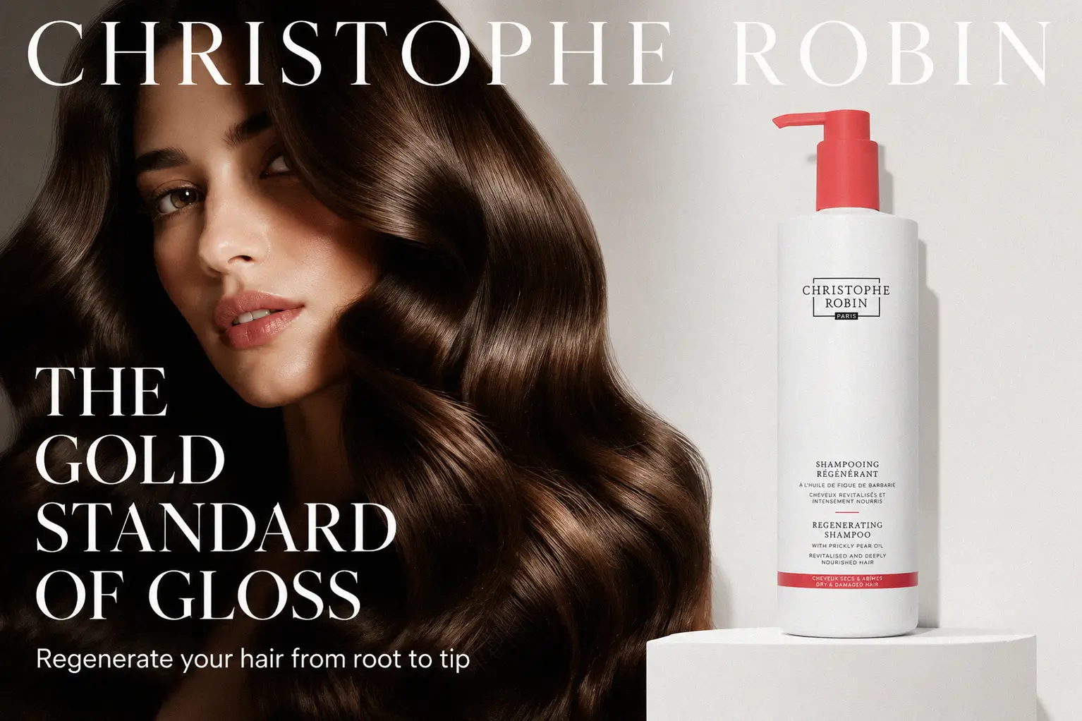 A tall bottle of Christophe Robin Regenerating Shampoo with Prickly Pear Oil on a polished marble surface.
