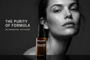 A tube of Grown Alchemist Age-Repair Treatment Cream standing on a clean marble vanity surface.
