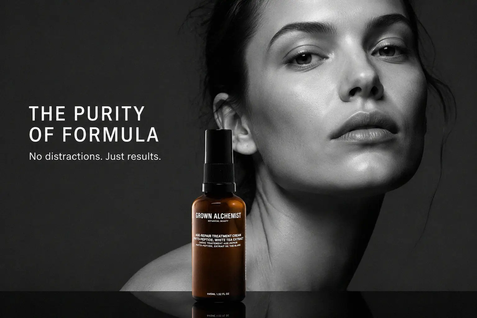 A tube of Grown Alchemist Age-Repair Treatment Cream standing on a clean marble vanity surface.