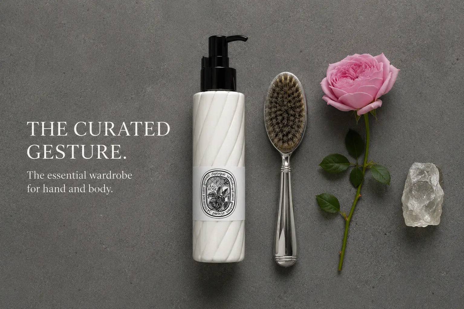 White Diptyque Eau Rose lotion bottle with elegant black and white label on a marble vanity.