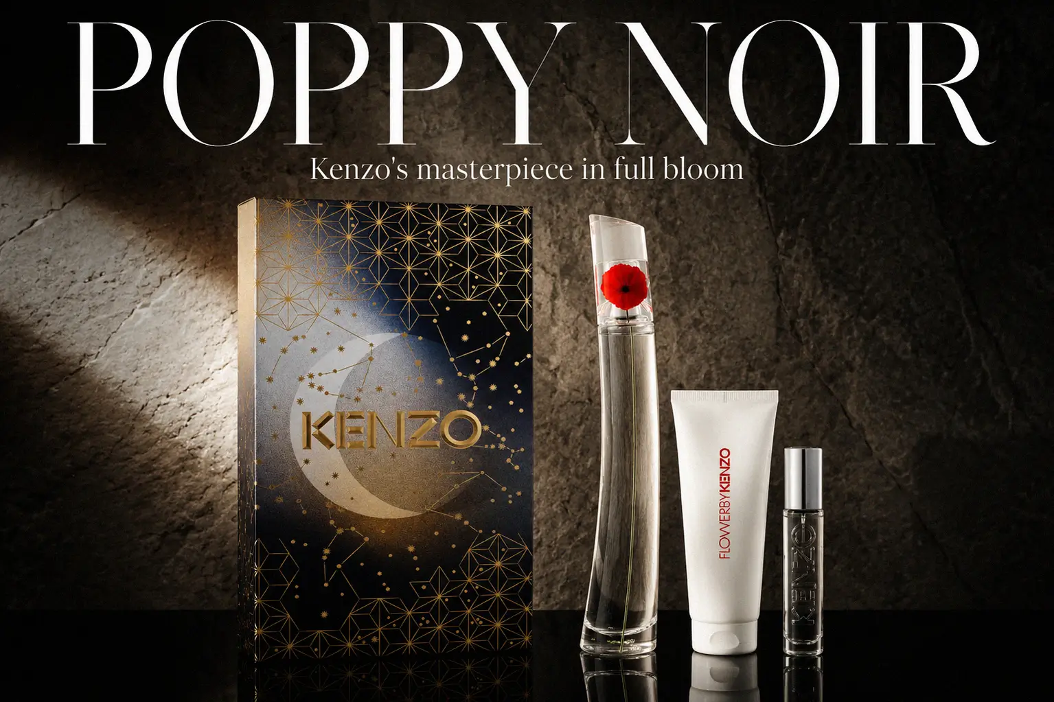 A red and white Kenzo gift box containing a tall curved bottle, a travel spray, and a tube of scented cream.