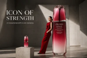 Two Shiseido Ultimune bottles, one large and one small, in red glass packaging for face and eyes.