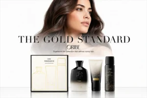 Oribe Obsessed Discovery Set on a marble surface with shampoo, conditioner, and texturizing spray bottles.