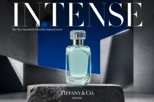 A faceted glass Tiffany & Co. Intense perfume bottle with silver detailing on a white background.